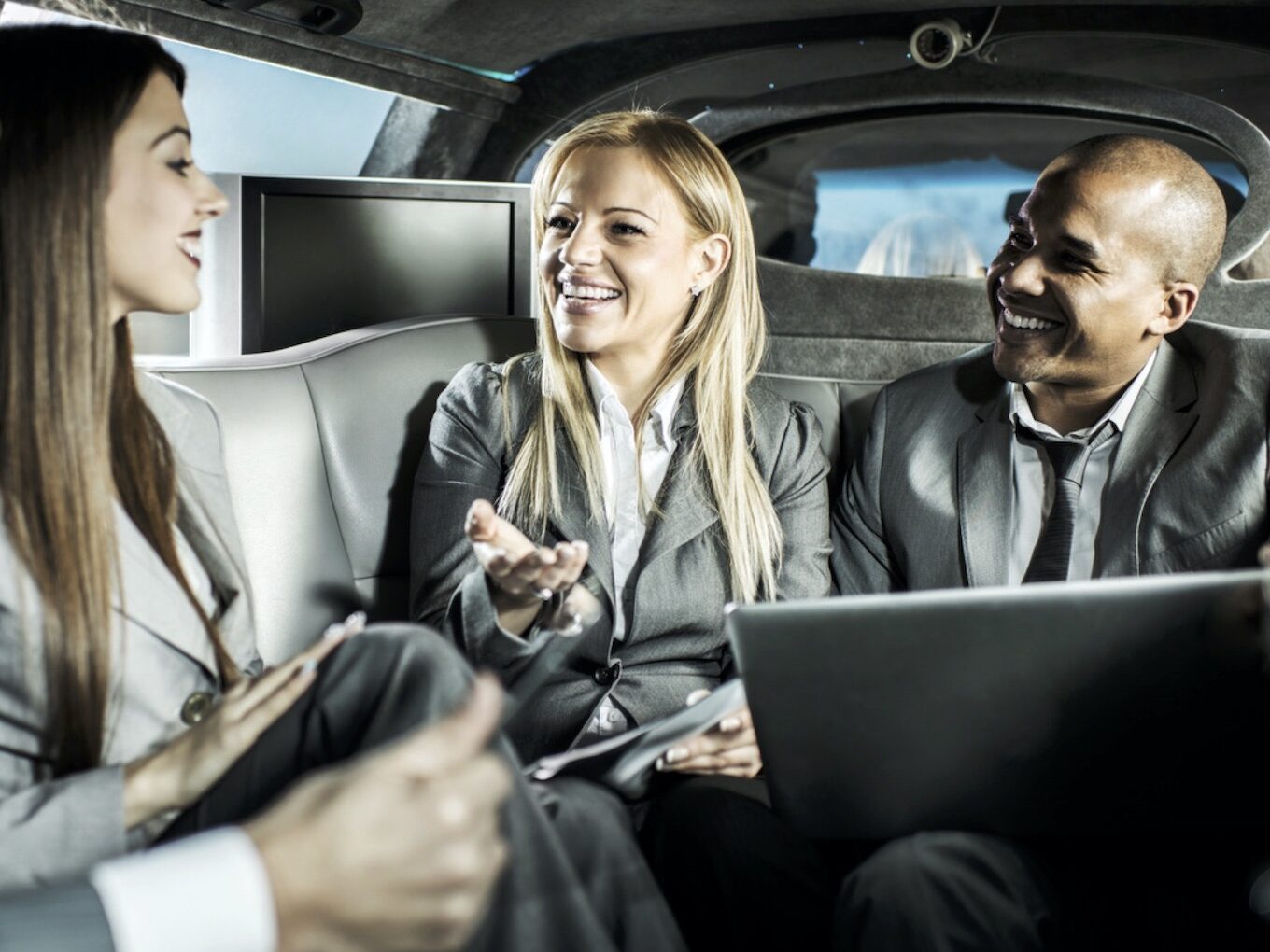 business people in the luxury car