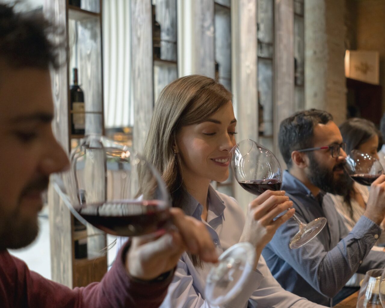 Group of people tasting wine at a cellar